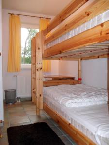 a bedroom with two bunk beds and a window at Meeresbrise in Neuhaus