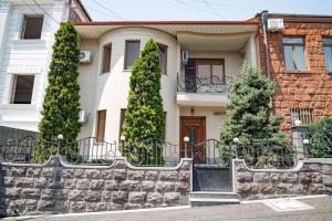 a house with trees in front of it at Marys Family Guest House in Yerevan