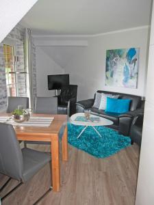 a living room with a table and a couch at "Landhaus Voss" Typ 4 Nr11 in Staberdorf