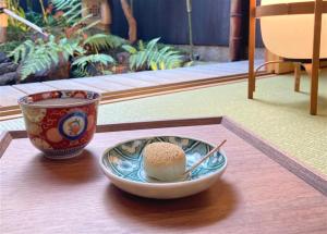 un bol de riz et une tasse sur une table dans l'établissement Kyo no Ondokoro Gokomachi Ebisugawa #3, à Kyoto