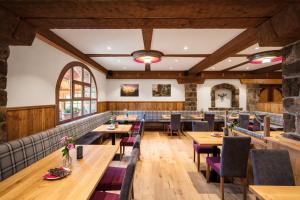 a dining room with wooden tables and chairs at Hotel Spinnerhof in Sasbachwalden