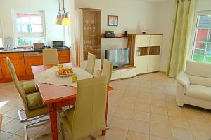 a kitchen and dining room with a table and chairs at Sonnenpalais in Zingst
