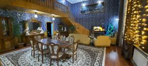 a dining room with a table and chairs and a christmas tree at Family holiday home. in Qusar