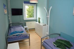 a hospital room with two beds and a window at FEWO Schleusenwärter 3 in Stralsund