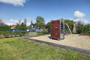 a playground with a rock wall and a slide at Altes Wasserwerk, FW 6 in Zingst