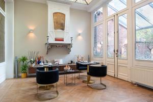 a room with a table and chairs and windows at Garden of Eden in Antwerp