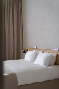 Postel nebo postele na pokoji v ubytování Hotel âme