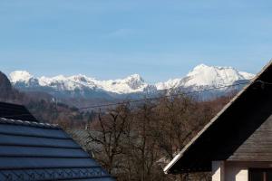 a view of snow capped mountains from a house at Bohinj - Old Village House in Bohinj