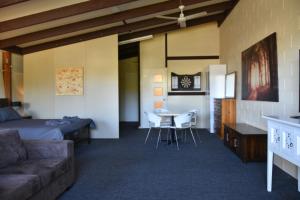a room with a bed and a couch and a table at The Studio in Middlemount