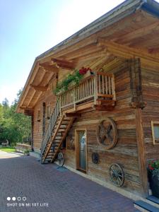 a wooden cabin with a staircase on the side of it at Leitingerhof in Virgen