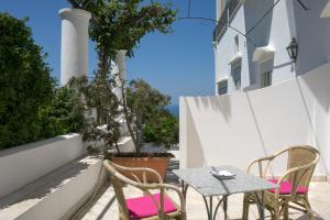 a patio with a table and two chairs and a table at Hotel Bellavista in Anacapri