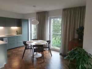 a kitchen and dining room with a table and chairs at Apartament LUMOS by Pedro Polanica in Polanica-Zdrój