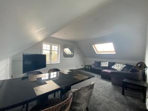 a living room with a table and a couch at Pristine 2 bedroom apartment with off street parking in Norwich