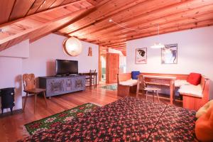 a living room with a table and a dining room at House Alpine Rose in Mojstrana