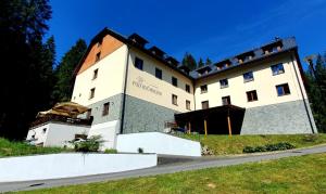 a large building on top of a hill at Wellness Hotel pod Kyčmolem in Horní Lomná