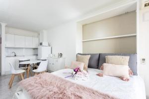 a living room with a couch with a pink blanket at Home2Book Sea Front Vista Marina, Los Cristianos in Arona