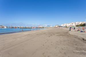 a beach with a lot of people on it at Home2Book Sea Front Vista Marina, Los Cristianos in Arona