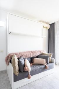 a couch with pillows on it in a living room at Home2Book Sea Front Vista Marina, Los Cristianos in Arona