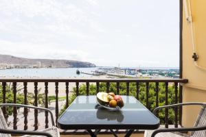 a bowl of fruit on a table on a balcony at Home2Book Sea Front Vista Marina, Los Cristianos in Arona