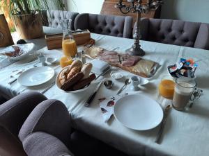 a white table with breakfast foods and orange juice on it at Sweetlake in Zoetermeer
