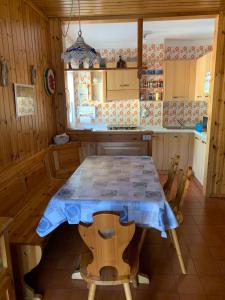 a kitchen with a table with a blue table cloth on it at Casa Lulu' in Predazzo