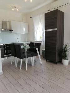 a kitchen with a table and some black chairs at Sweet Apartments in Split