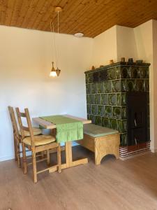 a dining room with a table and chairs and a fireplace at Ferienwohnung Traumblick in Schönau im Schwarzwald