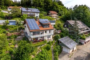 an aerial view of a house with solar panels on the roof at Ferienwohnung Traumblick in Schönau im Schwarzwald