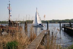 a sail boat in the water next to a dock at Michaelishaus in Werder