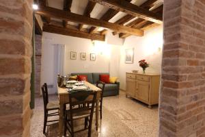 a living room with a table and a couch at Ca' del Pittor Apartments in Venice