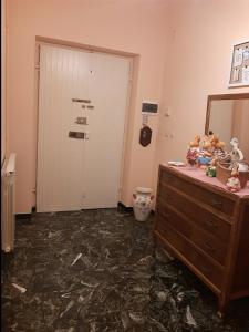 Zimmer mit einer Kommode, einem Spiegel und einer Tür in der Unterkunft La Tana Dei Conigli in Serra Rocco