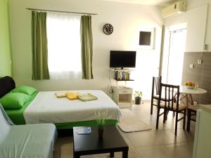 a small room with a bed and a living room at Apartmani Irena in Tivat