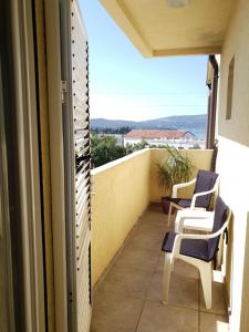a balcony with chairs and a view of the ocean at Apartmani Irena in Tivat