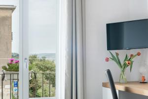 TV a/nebo společenská místnost v ubytování Aurà - Guest House Iblea
