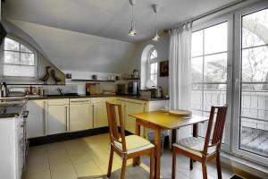 a kitchen with a table and chairs and windows at Catherin in Zingst