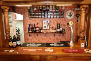 a bar with a counter with bottles of alcohol at The Raincliffe Hotel in Scarborough