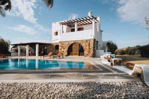 a villa with a swimming pool and a house at Saint Croix Villa in Káto Sangríon