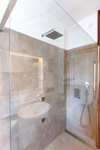 a bathroom with a sink and a shower at Attico Panoramico in Centro - Civetta in Belluno