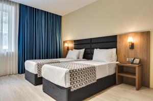 Кровать или кровати в номере Eleven Inn Tbilisi
