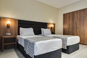 Кровать или кровати в номере Eleven Inn Tbilisi