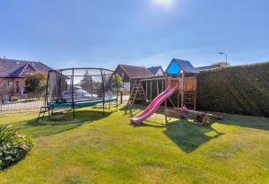 a yard with a playground with a slide at Haus im Grünen in Heringsdorf