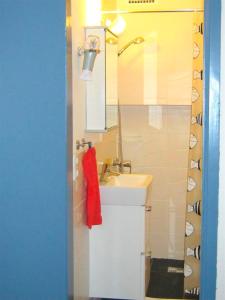 a bathroom with a sink and a red towel at "Das kleine Strandglück" in Grömitz