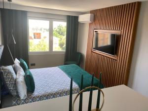 a small bedroom with a bed and a window at Ocean view, Luxury & Relax Dunas de Artola in Marbella +13 photos