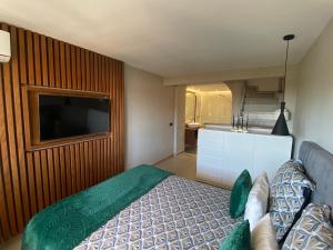 a bedroom with a bed and a flat screen tv at Ocean view, Luxury & Relax Dunas de Artola in Marbella