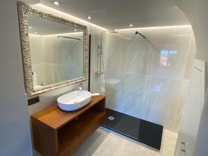 a bathroom with a sink and a shower with a mirror at Ocean view, Luxury & Relax Dunas de Artola in Marbella