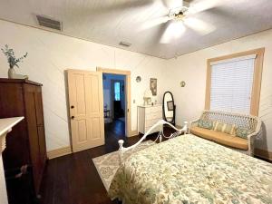 a bedroom with a bed and a ceiling fan at Grady House Bed and Breakfast in High Springs