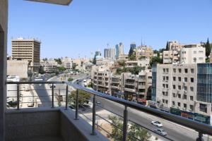 a view of the city from the balcony of a building at Amazing one Bedroom Apartment in Amman Elwebdah 5 in Amman