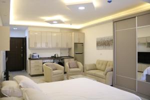 a living room with a bed and a kitchen at Amazing one Bedroom Apartment in Amman Elwebdah 5 in Amman