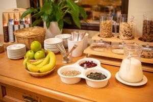 a counter with bowls of fruit and other food on it at Hotel Zum Steinhof in Bad Blankenburg