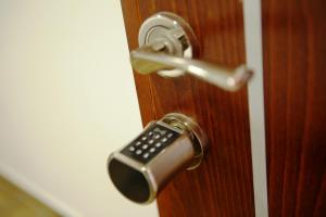 a door knob with a remote control on it at Alrowwad Guest House in Bethlehem